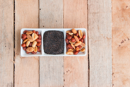 Sweet basil seed , nuts   on wood background. copyspace. diet concept