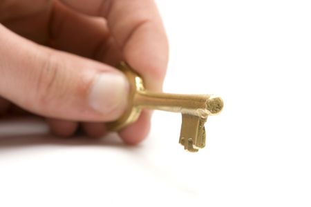 One golden and old key isolated on white backgroundの写真素材