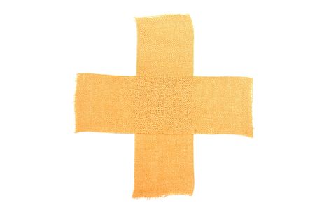 One isolated cross made of medical adhesiveの写真素材