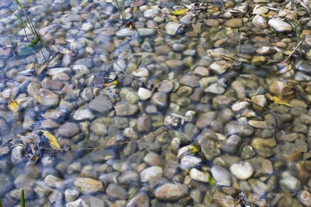 a pattern created by many stones in a little riverの写真素材