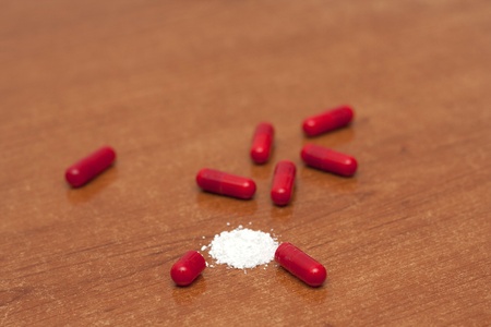 One tablet of red capsules; Narcotics standin in a tableの写真素材