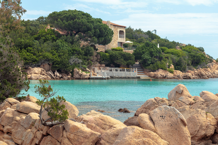 Beautiful beach house in rocky formations near a paradisiac beach in sardiniaの写真素材