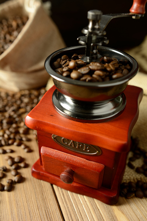 Coffee mill and coffee beans on dark backgroundの写真素材