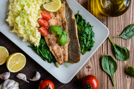 Baked rainbow trout fish with mashed potatoes and steamed spinachの写真素材