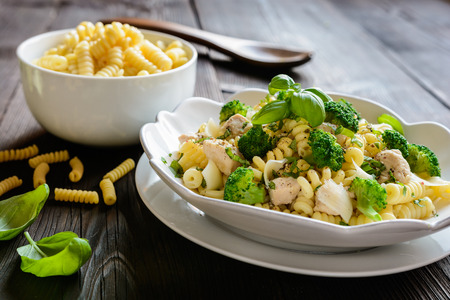 Macaroni pasta salad with fried chicken breast, steamed broccoli, cheese and basilの写真素材