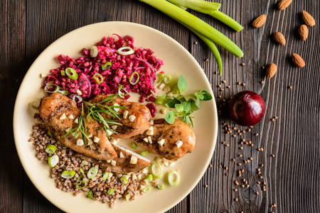 Baked chicken breast with boiled buckwheat and steamed beetroot and onionの写真素材