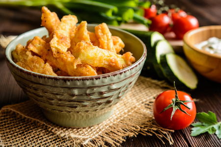 Deep - fried zucchini fries with sour cream dipping sauceの写真素材