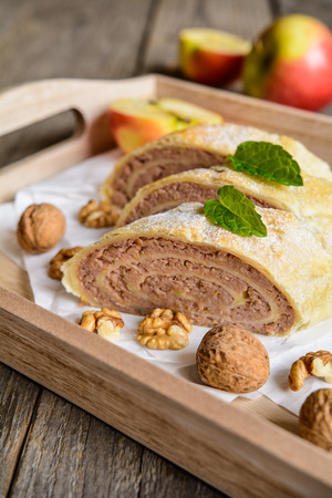 Sweet strudel stuffed with walnut and apple fillingの写真素材