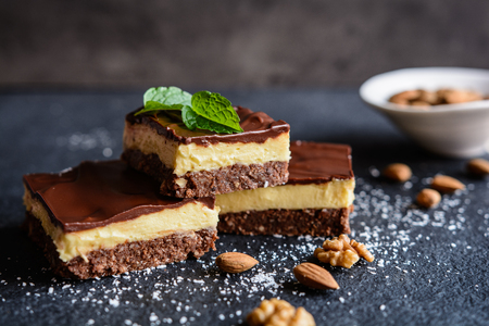 Nanaimo bars - traditional Canadian dessert with wafer crumbs, almond, walnut and cocoa layer, vanilla custard filling and chocolate toppingの写真素材