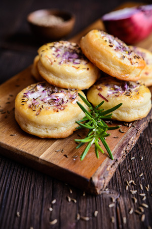 Small round pies with red onion and cuminの写真素材