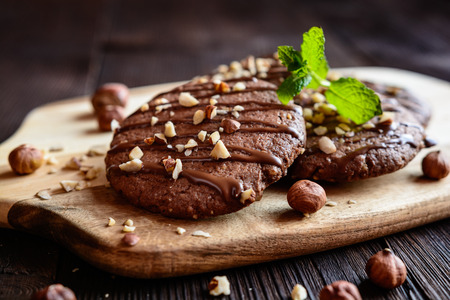 Delicious chocolate cookies with hazelnuts and toppingの写真素材