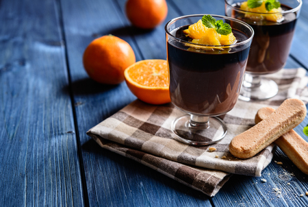 Chocolate pudding topped with orange piecesの写真素材