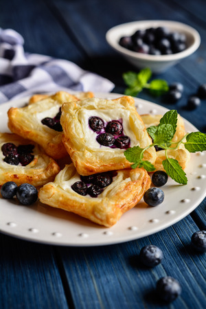 Baked small square cakes topped with ricotta and blueberryの写真素材