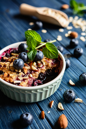 Baked blueberry crumble with oat flakes and chopped almondsの写真素材
