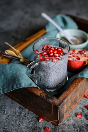 Raw chia pudding with pomegranate seeds in glass jarsの写真素材