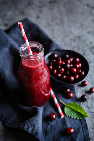 Healthy cranberry smoothie in a glass bottleの写真素材