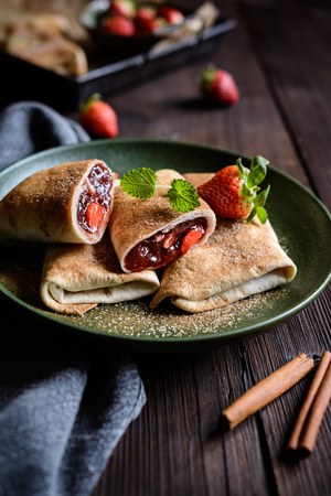 Sweet baked Chimichangas with strawberry filling and cinnamon sugar icingの写真素材