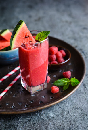 Refreshing watermelon and raspberry smoothie in a glass jarsの写真素材