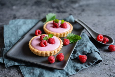 Sweet tartlets filled with raspberry mascarpone creamの写真素材