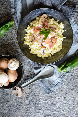 Delicious zucchini dumplings with roasted champignons, Prosciutto, grated, cheese and sour creamの写真素材