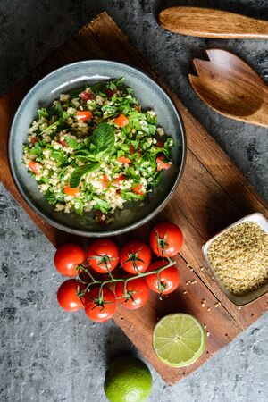 Refreshing vegetarian Tabbouleh salad with bulgur, parsley, mint, tomatoes and seasoningの写真素材