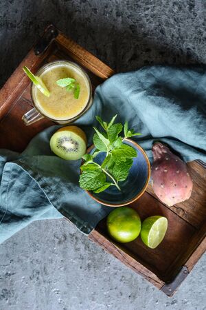 Sweet kiwi smoothie with prickly pear and lime juice in a glass jarの写真素材