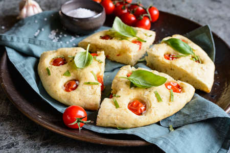 Sliced Italian Focaccia bread with tomatoes and basil