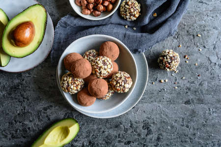 Raw chocolate avocado truffles with chopped hazelnuts