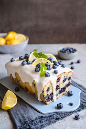 Fresh lemon blueberry loaf of bread cake with sugar glazeの写真素材