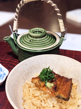 Japanese food, grilled eel with rice and green tea pot.の写真素材