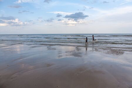 Boy and girl running on the beachの写真素材