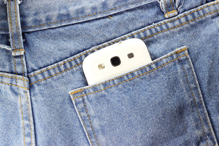 close up back side Texture of blue jeans with telephoneの写真素材