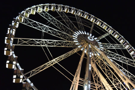 White ferris wheel over dark night skyの写真素材