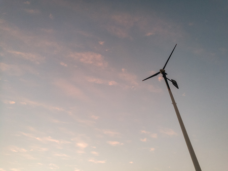 The 2 wind turbines The sky behind the sun is falling twilight sky,with space leftsideの写真素材