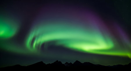 Aurora borealis in the night sky, northern lights over the mountainsの素材