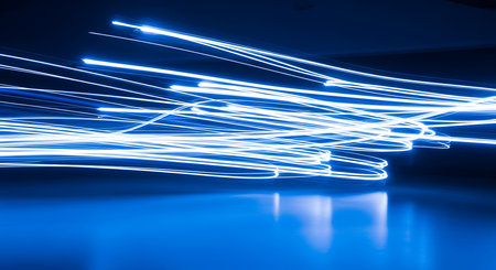 blue light trails on the black background. long exposure photo taken in the studioの素材