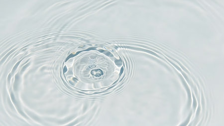 close up of a water drop on white background with ripples and wavesの素材