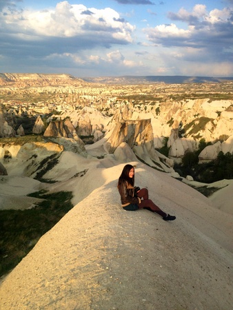 Woman with camera sitting in Cappadocia の素材