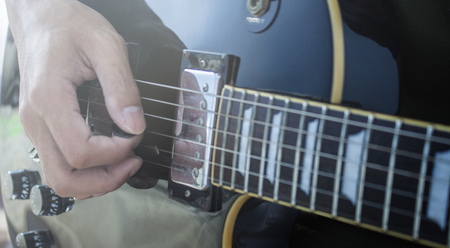 Playing electric guitar close-up