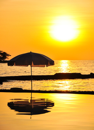 Sunset Swimming Pool with sea backgroundの写真素材