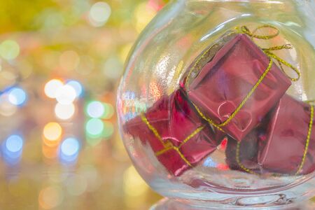 Small boxes gifts in the bottle on gold bokeh backgroundの写真素材