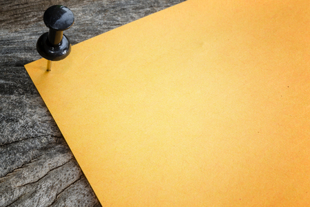 Sticky of orange paper note on wooden backgroundの写真素材