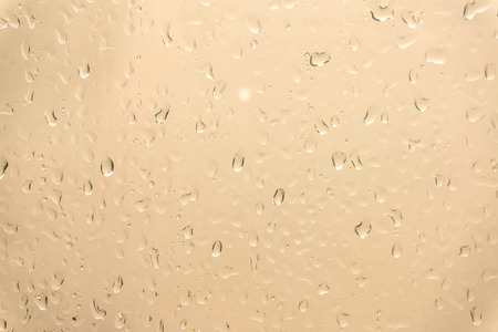 Drops of rain on glass , rain drops on clear window / water drops on glass after rain background / water drops / Small water drops on the glassの写真素材