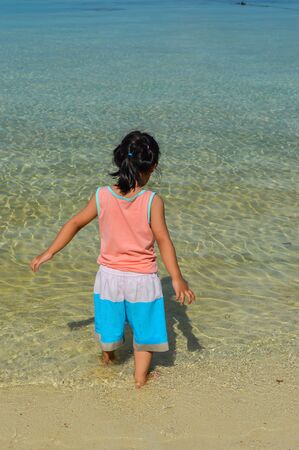 little kid laying at the sand and enjoying day at koh lipeの写真素材