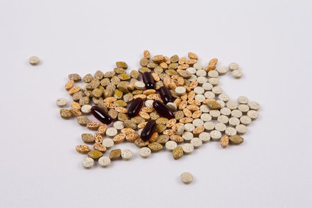 Pills and supplements on a white background. Focus on foreground, soft bokeh.の写真素材
