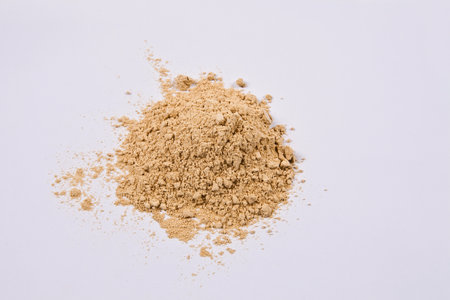 Pile of brown powder isolated on white background. Top view.の写真素材