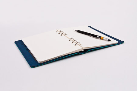 Notebook and pen on a white background, closeup of photo