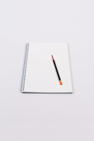Notebook and pencil on white background, business and education concept.