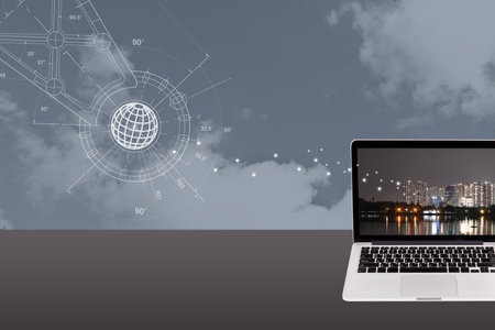 Laptop on the table with world map and cityscape background.の写真素材