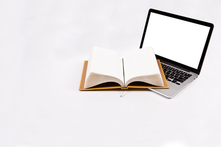 Open book with blank screen and laptop on white background, education concept